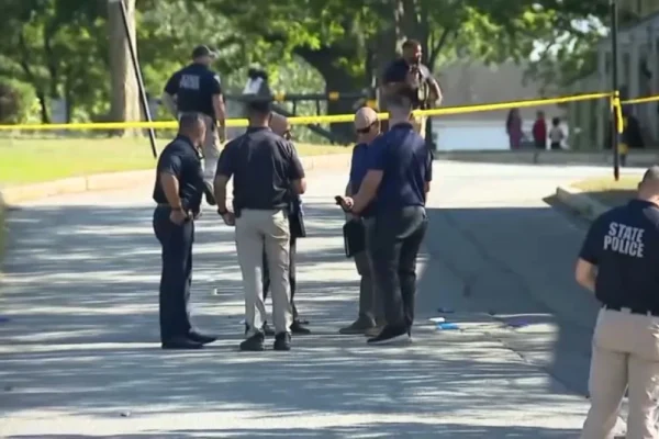 Police investigate a shooting scene near a school zone in Lawrence, Massachusetts