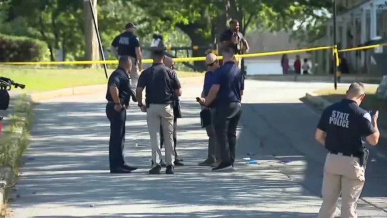 Police investigate a shooting scene near a school zone in Lawrence, Massachusetts