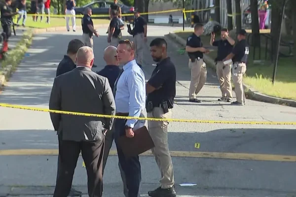 Police investigate a shooting scene near Lawrence High School in Lawrence, Massachusetts