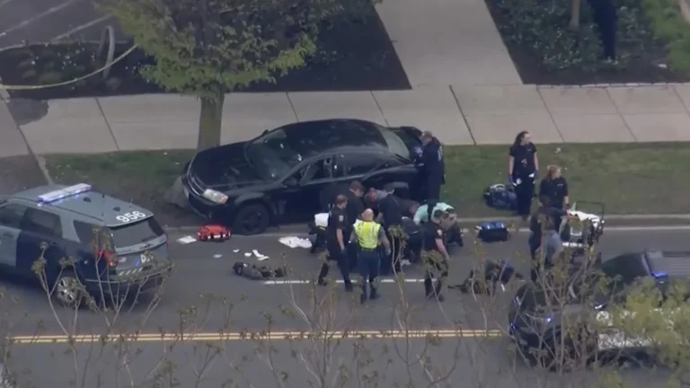 Police investigate a shooting scene near Memorial Drive and River Street in Cambridge, Massachusetts